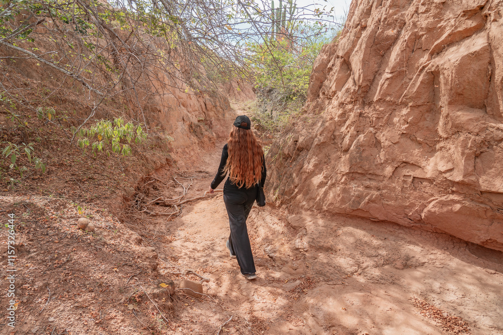 woman dressed in back in the tatacoa desert colombia woman dressed in back in the tatacoa desert colombia