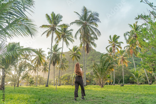 Woman between the palm trees. photo