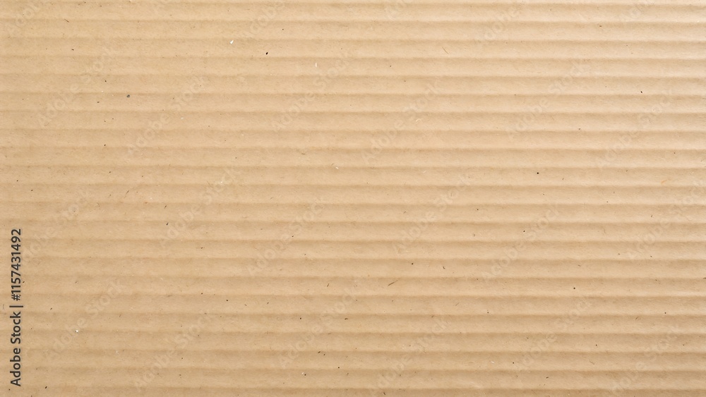 A detailed, top-down view of a smooth cardboard surface in a soft tan color A detailed, top-down view of a smooth cardboard surface in a soft tan color