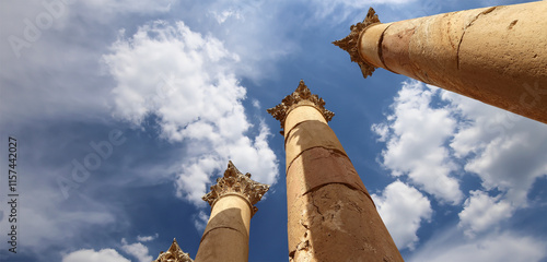 Roman Columns in the Jordanian city of Jerash (Gerasa of Antiquity), capital and largest city of Jerash Governorate, Jordan. Against the background of a beautiful sky with clouds #1157442027