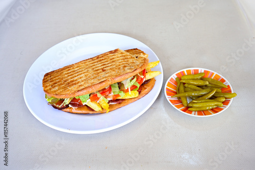 Turkish karisik atom kare  tost ( kasarli bazlama tost) . Sucuklu, Kasarli,  cheddarli, kavurmali karisik tost. Flat baked bread toasted. Karisik bazlama tost . photo