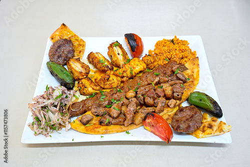 Famous Urfa meat liver, ciger wrapped by lavash with roasted chili pepper, onion and sauce in Sanliurfa, Turkey. Kuzu et ciger sis. Izgara dana bonfile, cop sis, kuzu pirzola. Karisik kebap, beyti keb photo