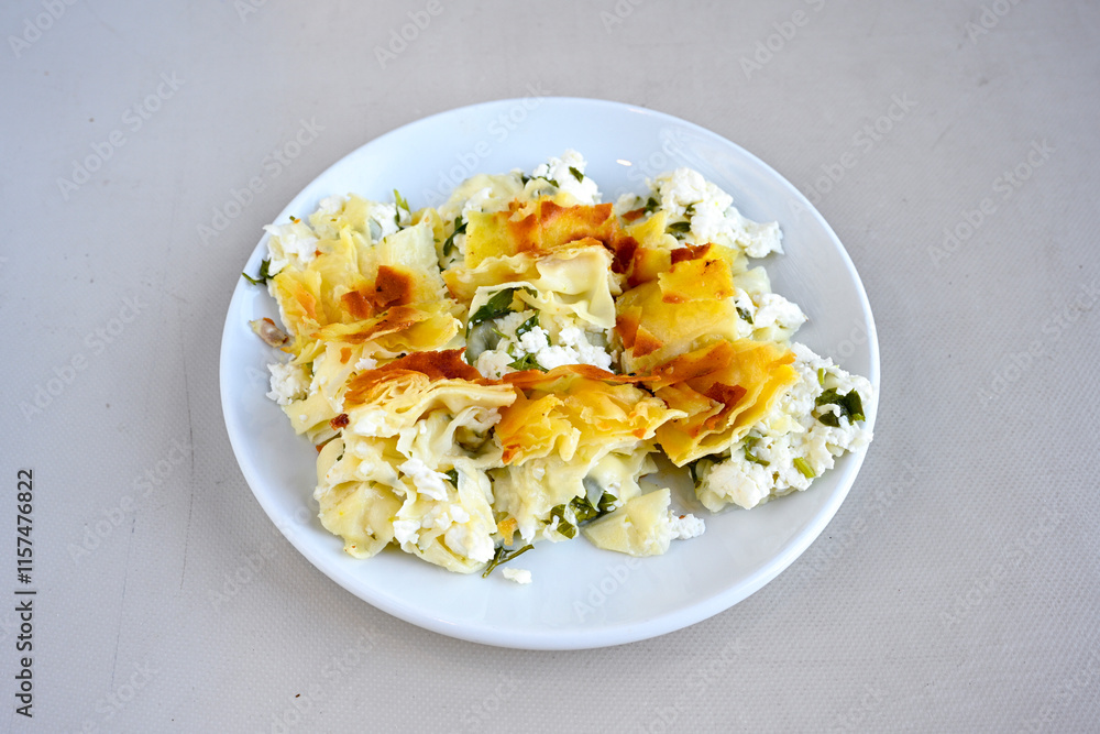 Turkish style meat stuffed filo dough borek served kol boregi.Cheese and minced pie are sliced on a marble background. Turkish name: Kol Boregi, kiymali, peynirli su boregi. Ci borek. Kafkas cig borek Turkish style meat stuffed filo dough borek served kol boregi.Cheese and minced pie are sliced on a marble background. Turkish name: Kol Boregi, kiymali, peynirli su boregi. Ci borek. Kafkas cig borek