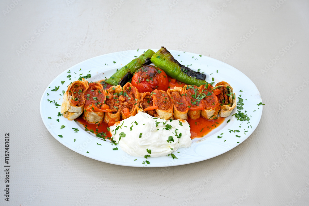Famous Urfa meat liver, ciger wrapped by lavash with roasted chili pepper, onion and sauce in Sanliurfa, Turkey. Kuzu et ciger sis. Izgara dana bonfile, cop sis, kuzu pirzola. Karisik kebap, beyti keb Famous Urfa meat liver, ciger wrapped by lavash with roasted chili pepper, onion and sauce in Sanliurfa, Turkey. Kuzu et ciger sis. Izgara dana bonfile, cop sis, kuzu pirzola. Karisik kebap, beyti keb