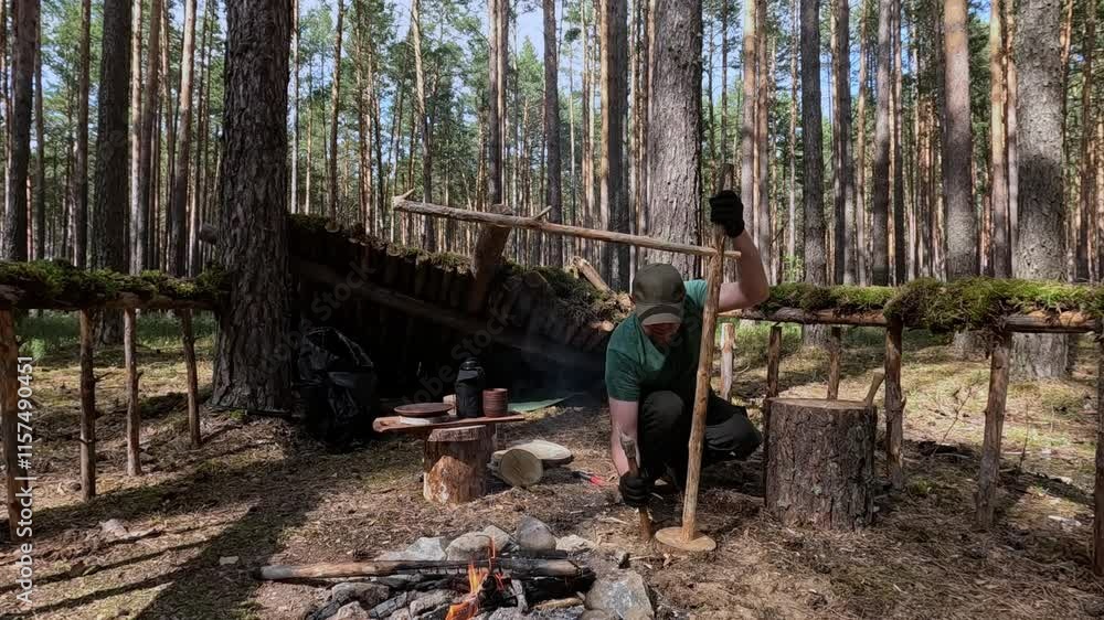 Man bushcrafts and survives in the forest Man bushcrafts and survives in the forest
