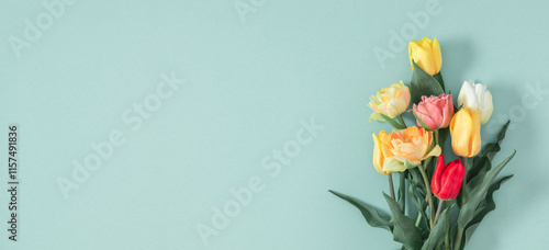 Beautiful bouquet of colorful tulip flowers on pastel background. Flower banner with tulips. Mother's day, Women's day, Easter, Birthday. Flat lay.