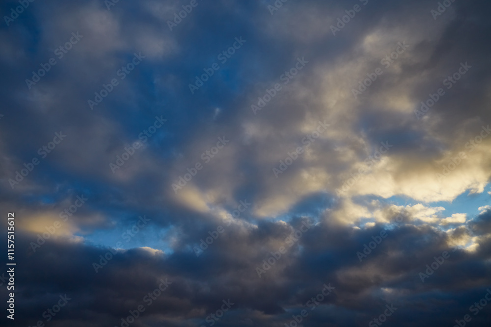 Winter sky with gray-white clouds illuminated by soft sunlight Winter sky with gray-white clouds illuminated by soft sunlight