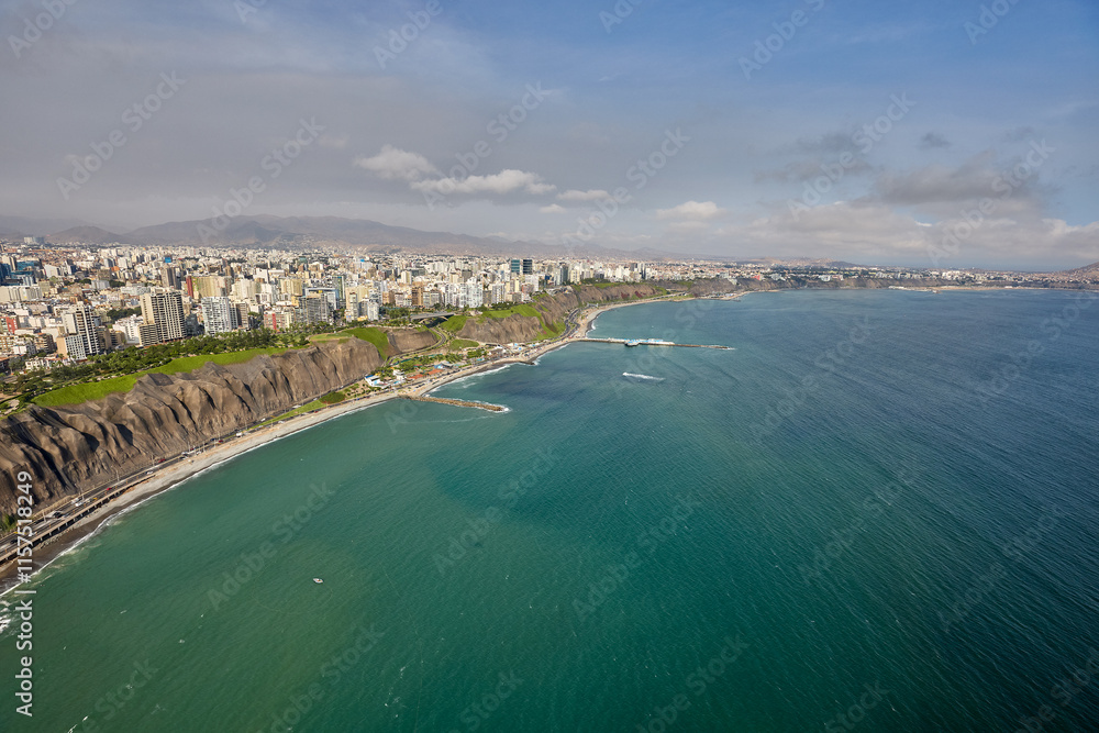 Fototapeta premium An aerial view of Lima’s Costa Verde reveals the perfect blend of urban life and natural beauty.With cliffs that kiss the Pacific and waves that call to surfers, this coastline is pure magic.