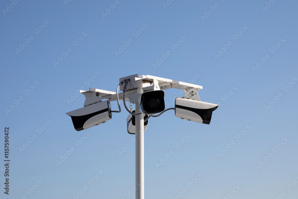 Security camera isolated on blue sky background Security camera isolated on blue sky background
