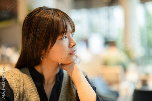 Photography Young woman thinking and pondering in london cafe