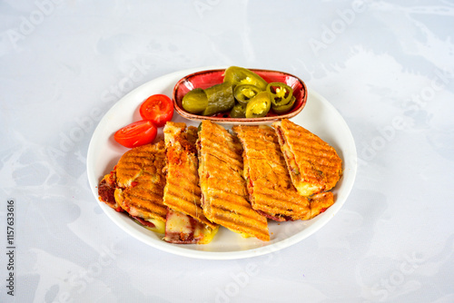 Turkish karisik atom kare  tost ( kasarli bazlama tost) . Sucuklu, Kasarli,  cheddarli, kavurmali karisik tost. Flat baked bread toasted. Karisik bazlama tost . photo