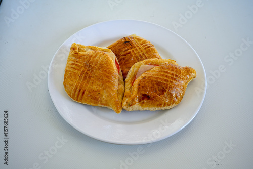 Turkish style meat stuffed filo dough borek served kol boregi.Cheese and minced pie are sliced on a marble background. Turkish name: Kol Boregi, kiymali, peynirli su boregi. Ci borek. Kafkas cig borek photo