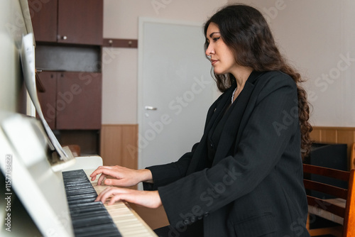 Pianist Elegantly Performing on a Grand Piano in a Cozy Room photo