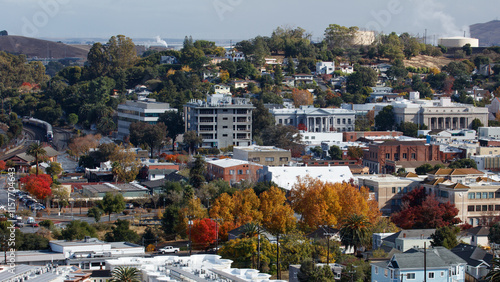 An 16x9 format image of the city of Martinez, California. The government buildings can be seen as well as an Amtrak train.
