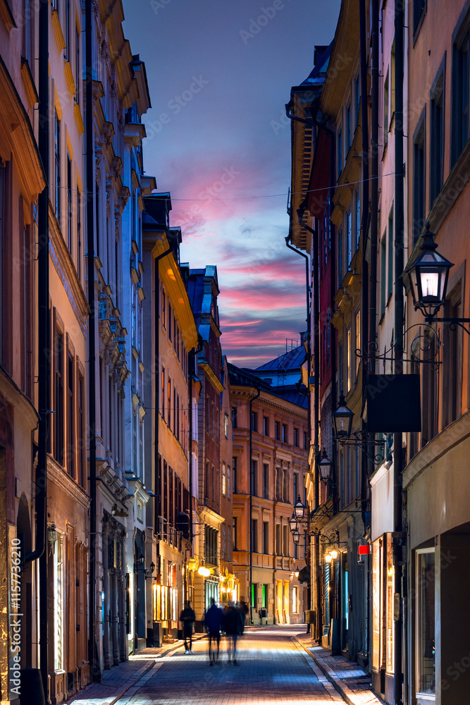 Picturesque scene of charming street in the Old Town of Stockholm with colorful buildings against beautiful sunset