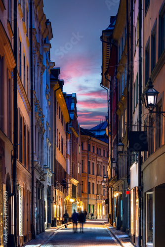 Obraz na płótnie Picturesque scene of charming street in the Old Town of Stockholm with colorful buildings against beautiful sunset w salonie