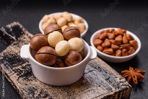 Delicious nutritious macadamia nuts in ceramic bowl photo