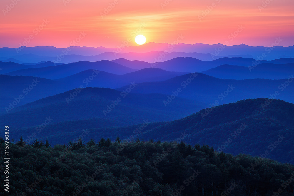 Obraz premium Sunset over layered blue mountains, serene landscape.