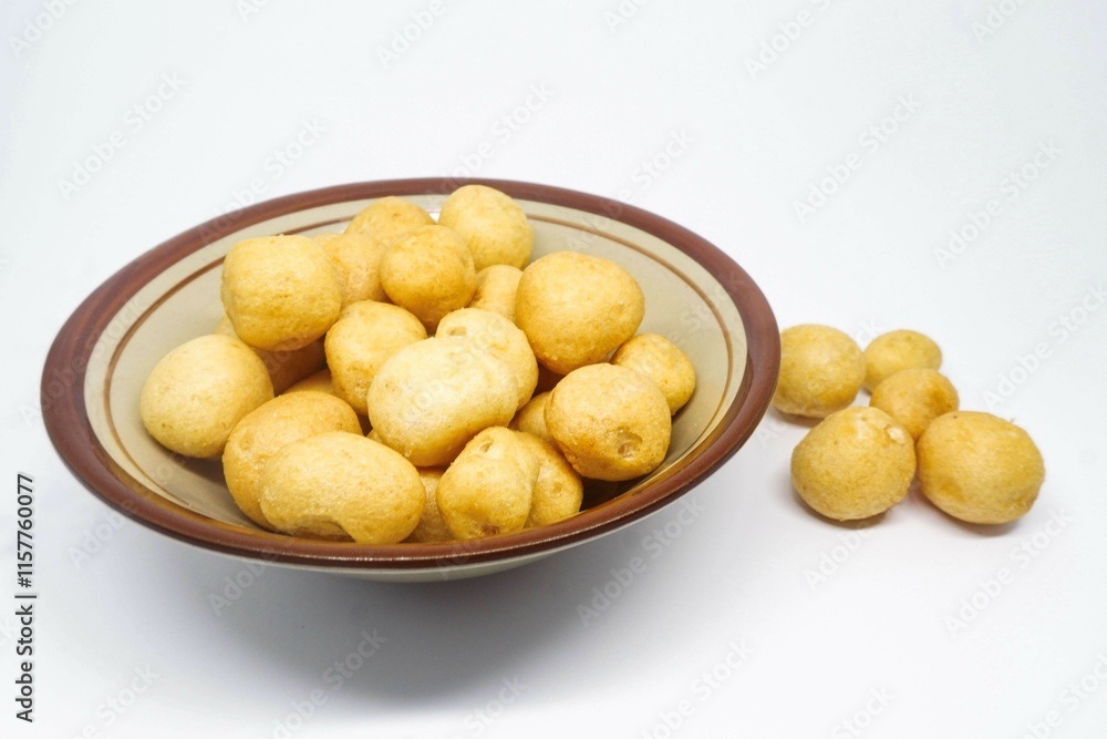 a bowl of crackers made from fried mackerel, crunchy and savory taste a bowl of crackers made from fried mackerel, crunchy and savory taste