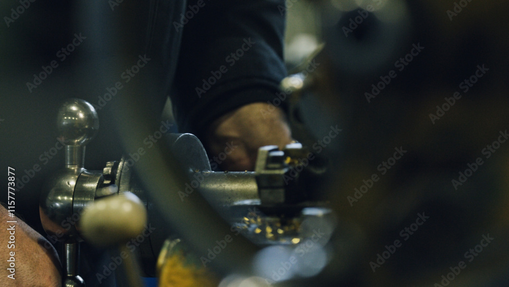 Close up of a metalworker's hands skillfully operating a lathe machine, creating precision metal parts in a factory workshop, showcasing industrial manufacturing processes Close up of a metalworker's hands skillfully operating a lathe machine, creating precision metal parts in a factory workshop, showcasing industrial manufacturing processes