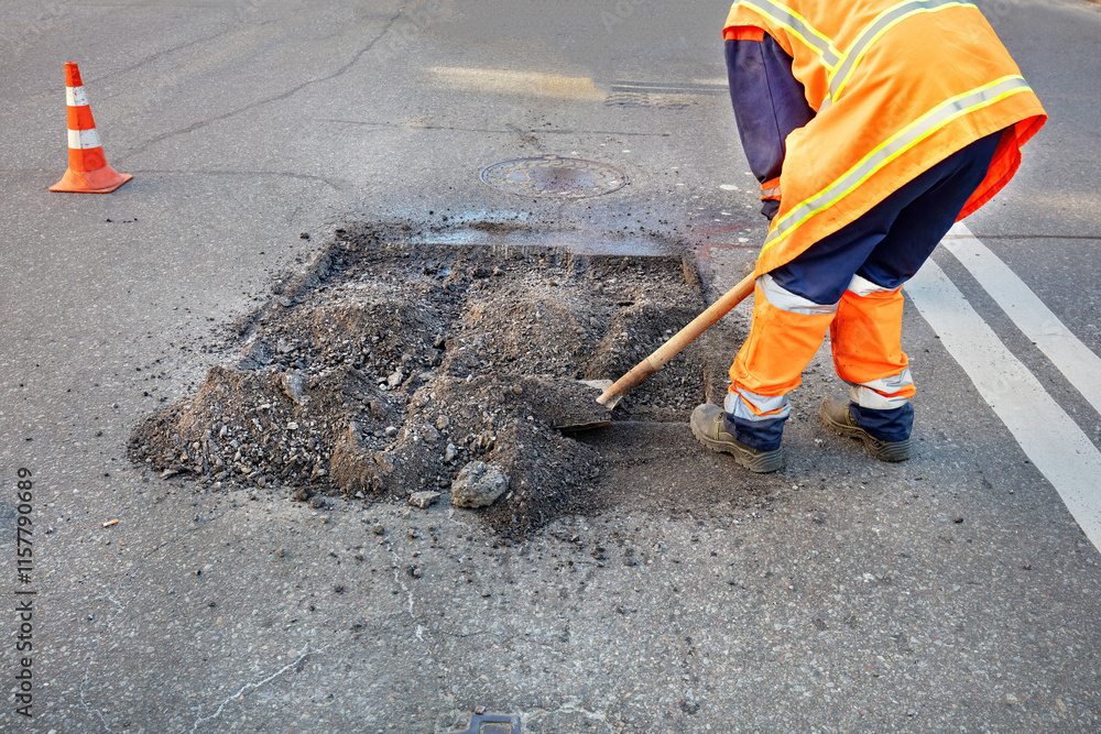 Road repair crew diligently works to fix pothole during sunny afternoon