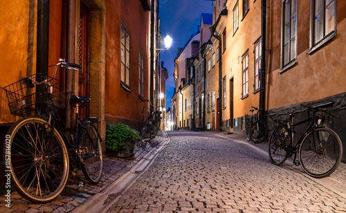 Charming urban scene of residential buildings in Old Town of Stockholm with bicycles leaning against the buildings at dusk