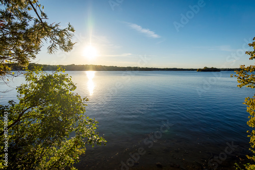 Fototapeta Naklejka Na Ścianę i Meble -  Sun in the late afternoon on a Wisconsin lake in early October.