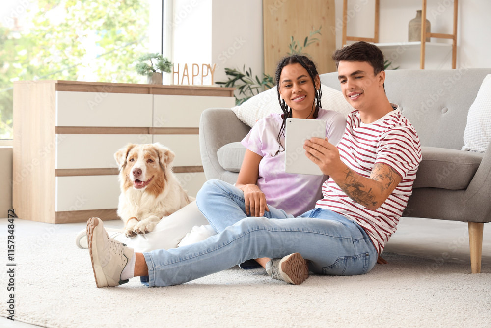 Young couple with cute dog using tablet computer at home Young couple with cute dog using tablet computer at home