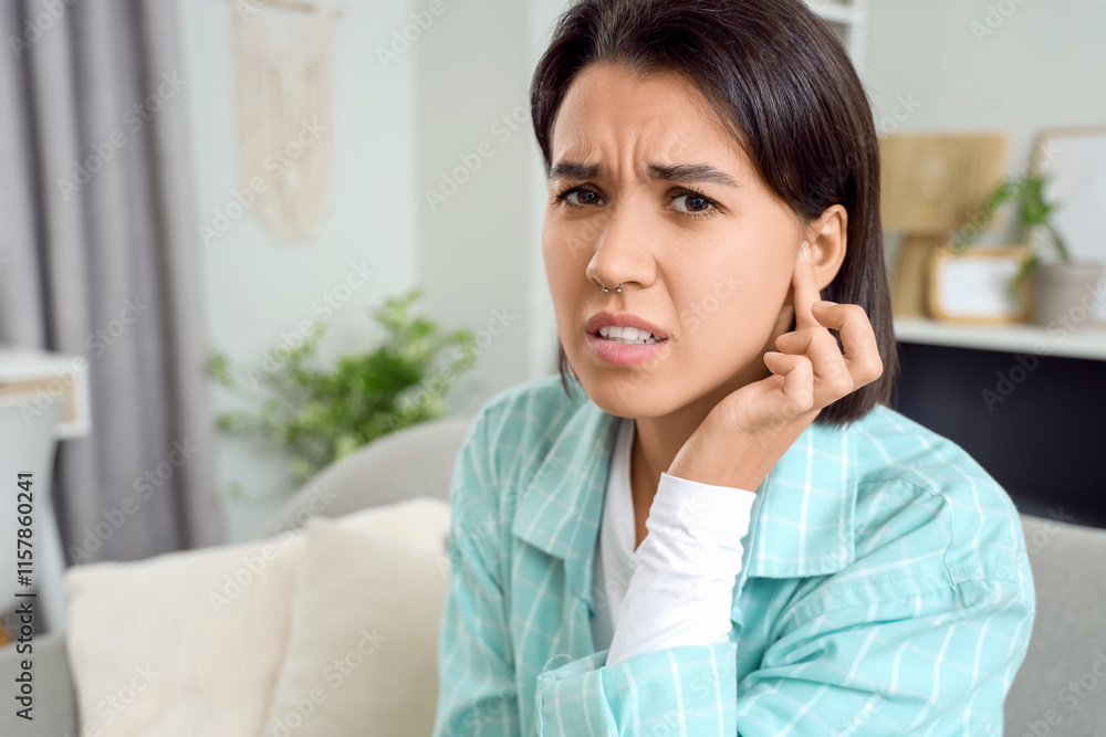 Young girl with otitis feeling pain in ear at home Young girl with otitis feeling pain in ear at home