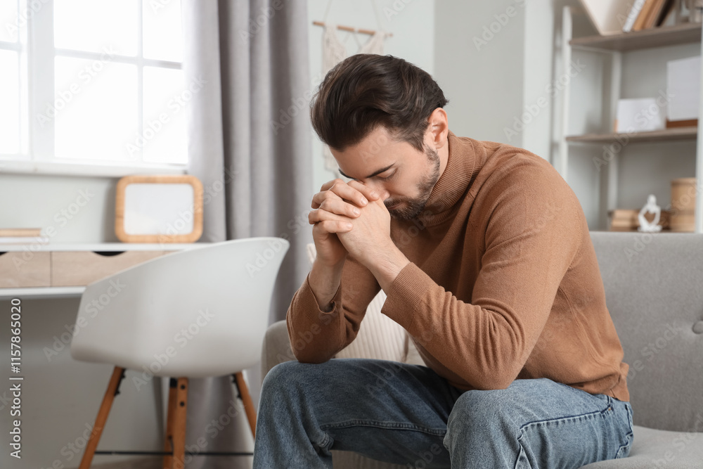 Religious man praying at  home