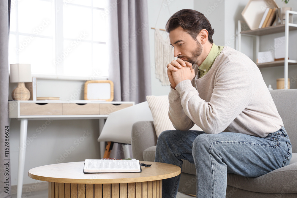 Religious man reading Bible at home Religious man reading Bible at home