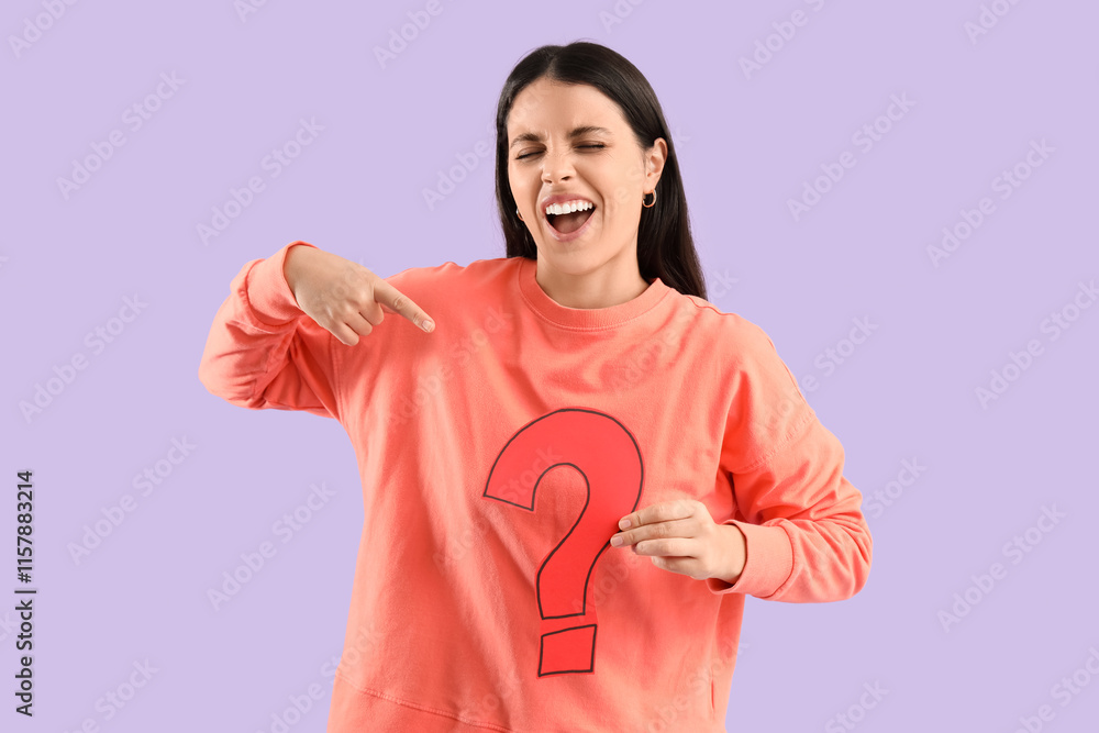 Young woman pointing at paper question mark on lilac background Young woman pointing at paper question mark on lilac background