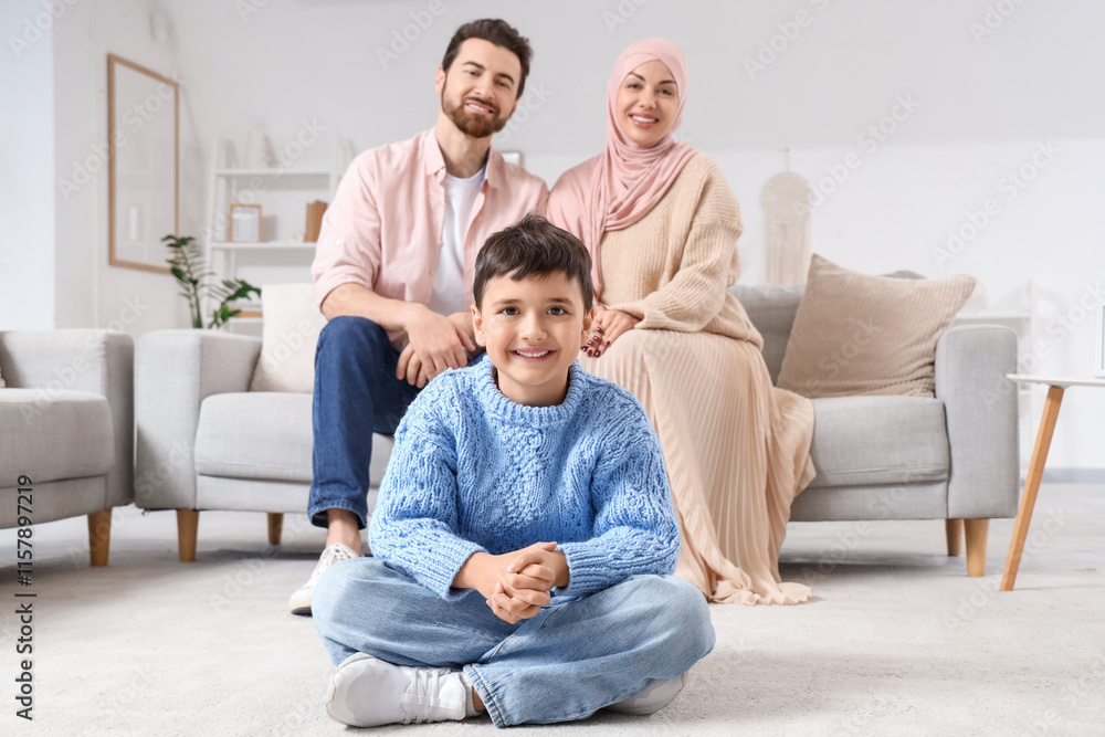 Happy Muslim boy and his parents sitting at home Happy Muslim boy and his parents sitting at home