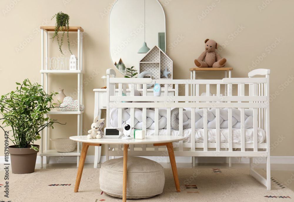 Interior of children's bedroom with crib, shelf unit and baby monitor on table Interior of children's bedroom with crib, shelf unit and baby monitor on table