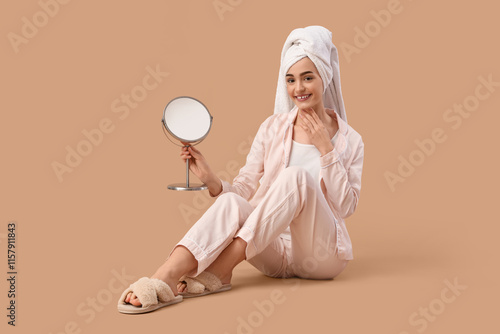 Young woman with mirror sit...