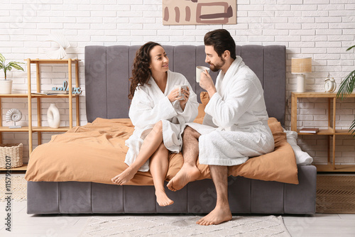 Happy couple in bathrobes w...