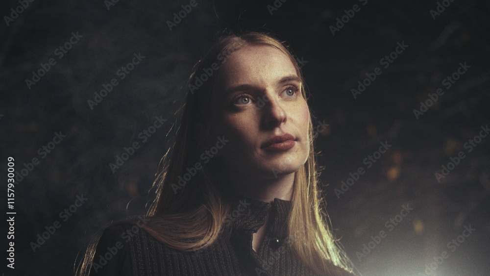 Fototapeta premium Young woman posing in nature with dramatic