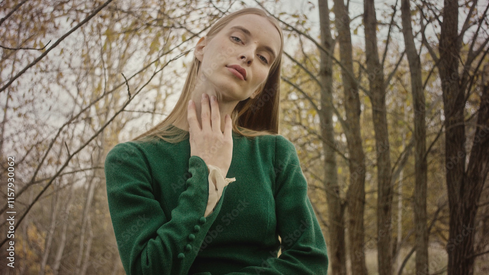 Fashion model posing in green dress in autumn Fashion model posing in green dress in autumn