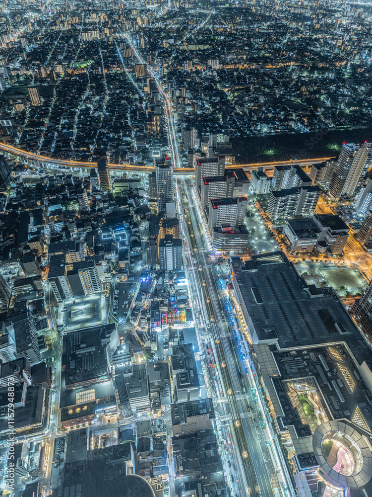Fototapeta premium Top view of an Asian big city and many cars crossing at night, Abeno Harukas Observatory in Osaka in Japan, Travel or business, High resolution over 50MP