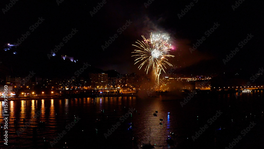 Nocturne aerial view of the fireworks launched in the beach of El Postiguet, in the Mediterranean city of Alicante, Spain. Nocturne aerial view of the fireworks launched in the beach of El Postiguet, in the Mediterranean city of Alicante, Spain.