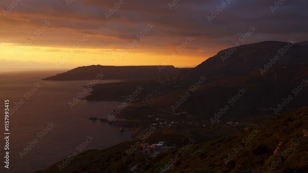 Woman looking at Mani Peninsula with coastal villages at sunset, in Greece Woman looking at Mani Peninsula with coastal villages at sunset, in Greece