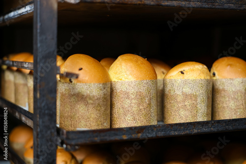 A rack of bread loaves with a paper wrapper around them, Easter baking at the factory photo