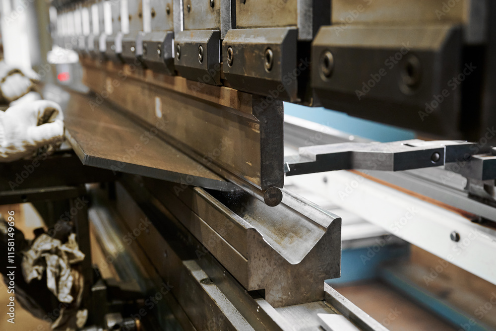 Bending machine operates with heavy metal plate in shop Bending machine operates with heavy metal plate in shop
