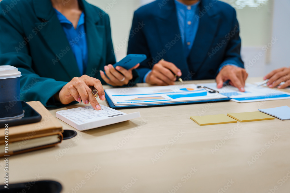 Close-up of three business people's hands during a meeting at an office table.They are engaged in discussions,planning,analyzing finance, investments, and market trends during a monthly team meeting Close-up of three business people's hands during a meeting at an office table.They are engaged in discussions,planning,analyzing finance, investments, and market trends during a monthly team meeting