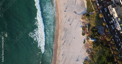 Top Down Aerial View Above Camps Bay Beach during Golden Hour in Cape Town, South Africa.