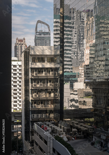 Obraz na płótnie Beautiful view of modern building in the city ??center of bangkok. Steel frame and glass windows architecture, use it as your Wallpaper, Poster and Space for text, Selective focus. w salonie