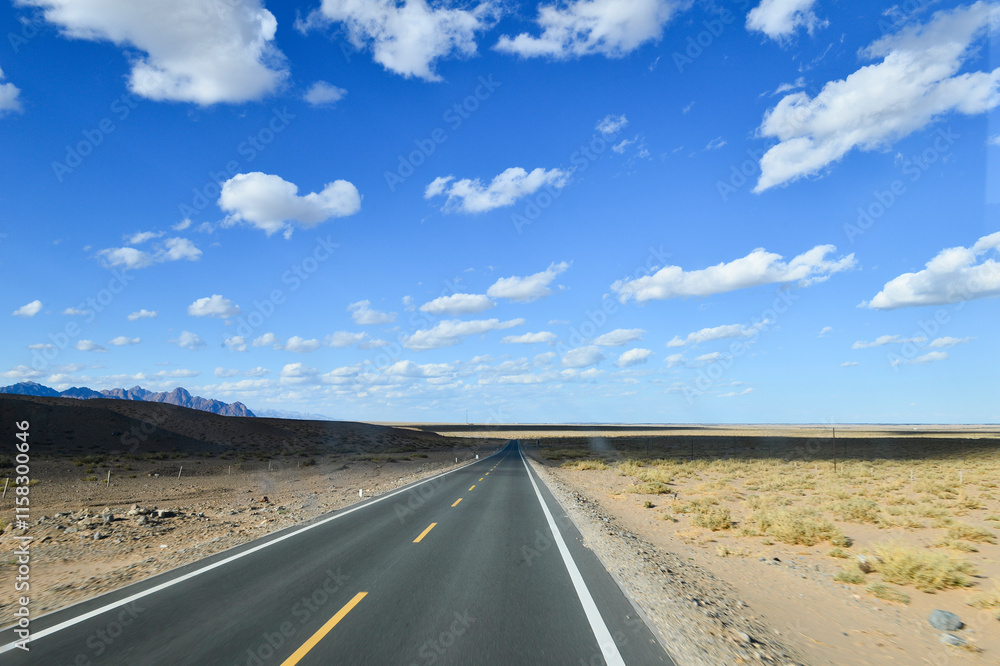 Naklejka premium Desert road sand dunes in Xinjiang, China