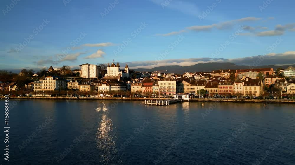 Orbit drone shot of Nyon cityscape, castle and port at sunrise in Canton of Vaud Switzerland Orbit drone shot of Nyon cityscape, castle and port at sunrise in Canton of Vaud Switzerland