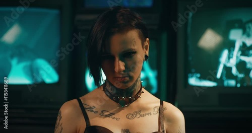 Aggressive young woman with tattoos and piercings looking at camera, portrait. Subculture of gothic and rock, alternative style, alt woman, self-expression by appearance, deviant behavior of youth