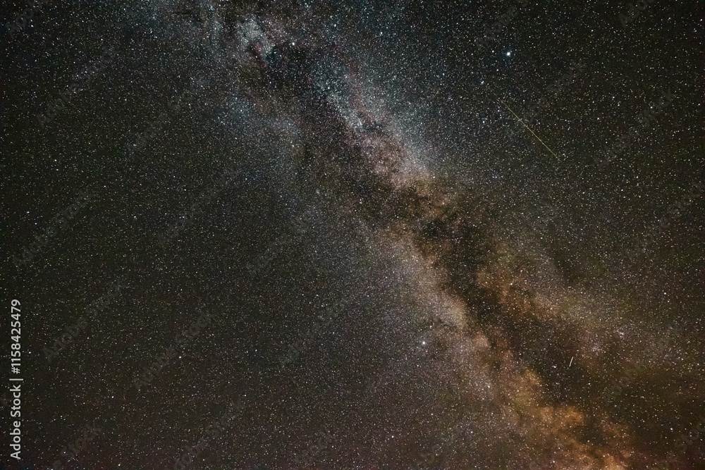 Fototapeta premium Starry night background photo. The Milky Way with a meteor